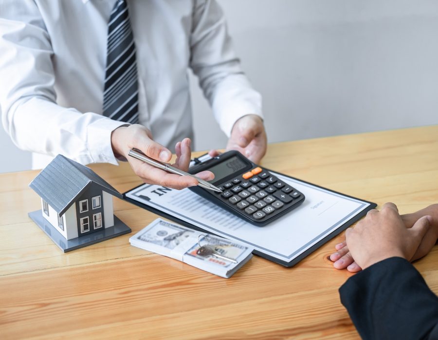 estate-agent-are-presenting-home-loan-and-giving-house-to-client-after-signing-agreement-contract.jpg